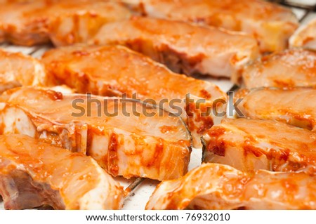 sturgeon filets marinated in tomato sauce