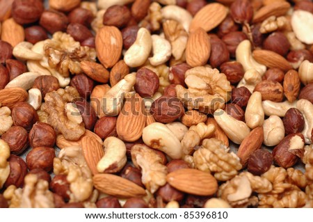 Background of mixed nuts - pecans, hazelnuts, walnuts, cashews, almonds, pine nuts, pistachios,