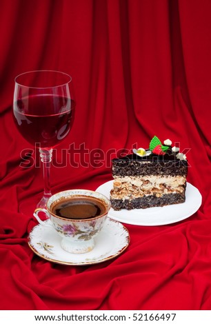 poppy cake with hazelnut Bizet, coffee and wine on a red background