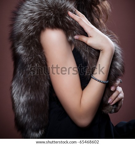 Woman in silver fox fur, focus on fur.  Fashion art photo.