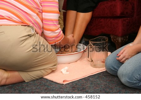 Girl washing a woman\'s feet in appreciation