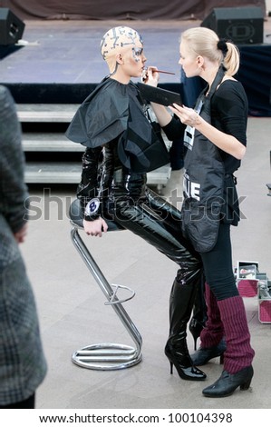 MOSCOW, RUSSIA-FEBRUARY 11: Stylist and model prepare on the IX Open Championship for creative makeup KOSMETIK international on February 11, 2012 in Moscow, Russia. Theme \