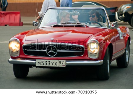 stock photo MOSCOW MAY 15 unidentified man in red vintage Mercedes on 
