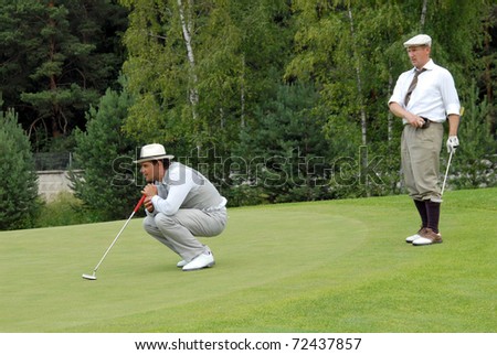 MOSCOW - JULY 05: Group Russian unknown golfers finishes his swing on annual open international event  for professionals and fans - VI Moscow Festival Retrostyle July 05, 2007 in Moscow, Russia