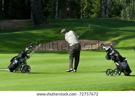 MOSCOW - AUGUST 8: An unidentified golfer finishes his swing at the annual VI Moscow Festival Retrostyle event for fans and professionals at the Le Meridien Moscow County Club on August 8, 2008 in Moscow, Russia