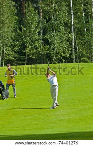 MOSCOW - AUGUST 08: unknown golfer finishes his swing on annual international event  for professionals and fans - VI Moscow Festival Retrostyle in Moscow County Club August 08, 2008 in Moscow, Russia