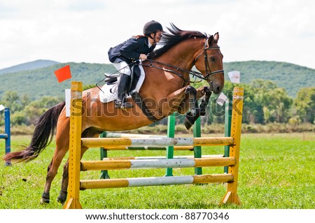 ARSENEV, RUSSIA - SEPTEMBER 03: Unidentified child-rider in action jumps over a hurdle at horse on the show jumps 