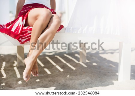 Woman\'s legs at beach at sunny day