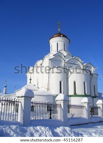 Orthodox church covered with snow under blue sky