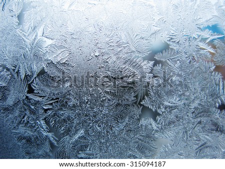 snowflakes ornament on glass winter texture background