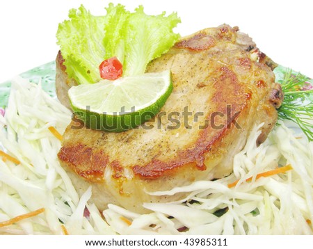 cooked meat with cabbage salad and lime isolated