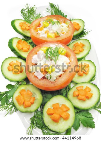 stuffed red tomato with cucumber carrot and parsley