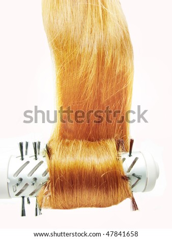 hair brush electric dryer with long red hair in it