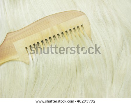 wooden hair brush brushing shiny blond hair