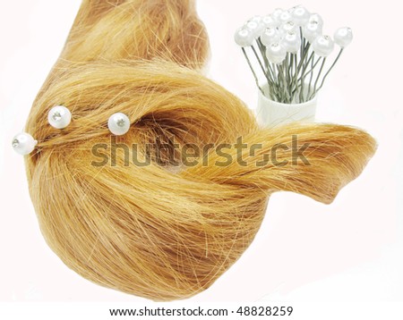 gingery hair coiffure with white pearl pins inside isolated on white background