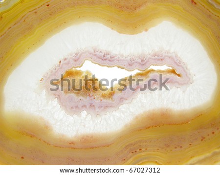 pink and yellow agate geode mineral crystal isolated