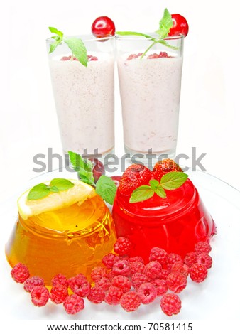 jelly orange and red dessert with raspberry and strawberry and two alcohol cocktails