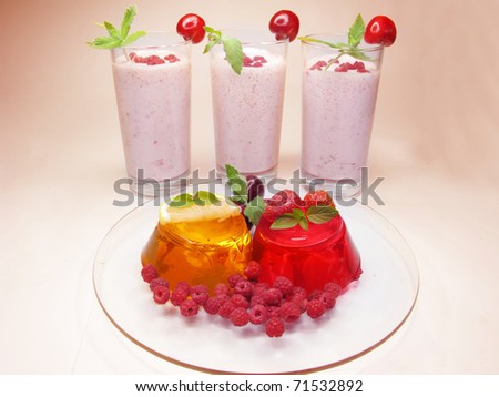 jelly orange and red dessert with raspberry and strawberry and two alcohol cocktails