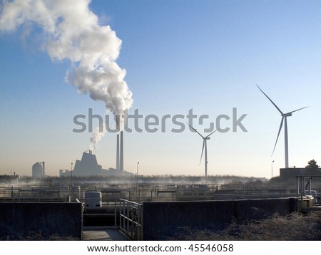 traditional factory with a lot of smoke side by side with the energy of the future