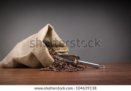 Burlap sack full of coffee beans with metal scoop