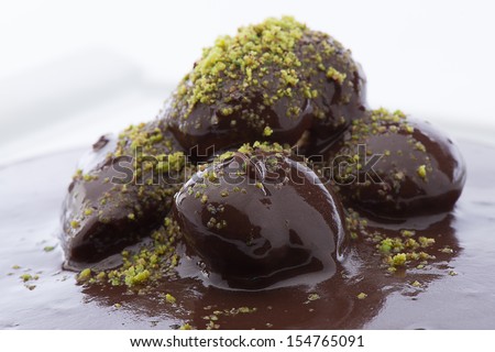 Close up of flowing down chocolate on profiterole