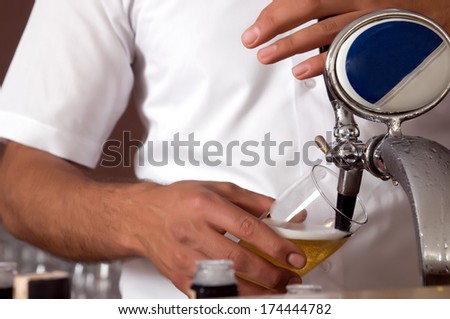 Bartender pouring beer from tap