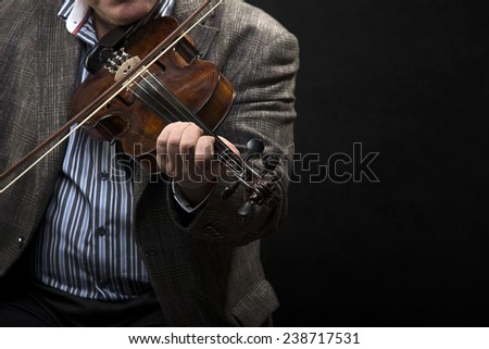 Violin player over black background with space for your text.
