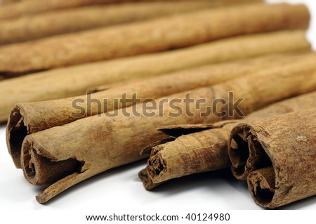 Close up of cinnamon sticks on white background