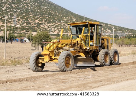 A construction vehicle flattening a road