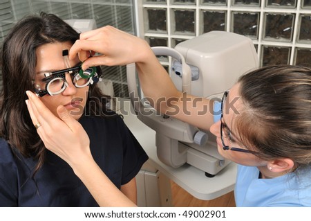 Beautiful young female patient having a medical examination at optician - a series of eye exam related pictures.