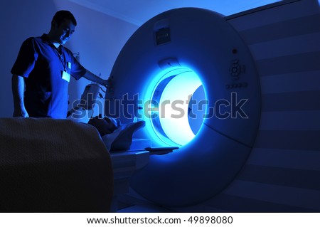 Magnetic Resonance Imaging machine operator and a patient -a series of MRI.