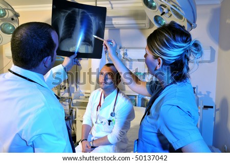 Medical doctors and a nurse looking at x-ray - a series of emergency room photos.