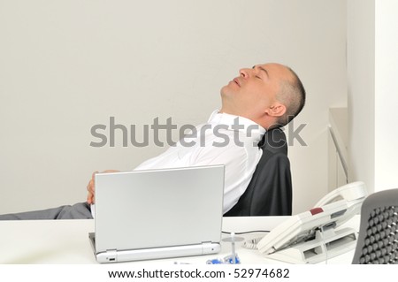 A stressed bald businessman sleeping at office â?? a series of OFFICE related images.