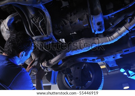 Auto mechanic working under the car - a series of MECHANIC related images.