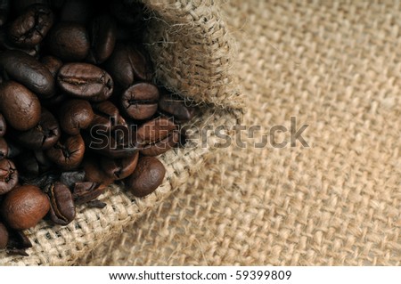 Coffee beans in jute coffee bag with copy space.