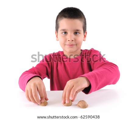 Cute boy playing traditional shell game with three walnut shells - a series of SHELL GAME images.