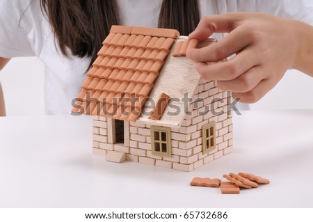 Cool girl building house isolated on white - a series of BUILDING A HOUSE images.