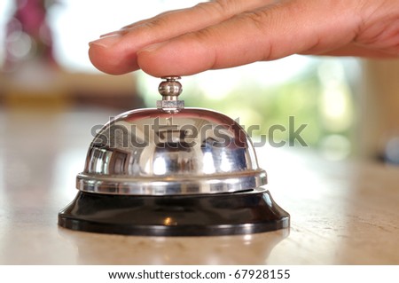 Hand of a man using a hotel bell - a series of HOTEL images.