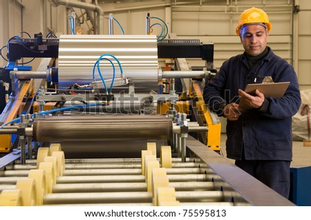 Factory worker processing roll of steel sheet - a series of METAL INDUSTRY images.