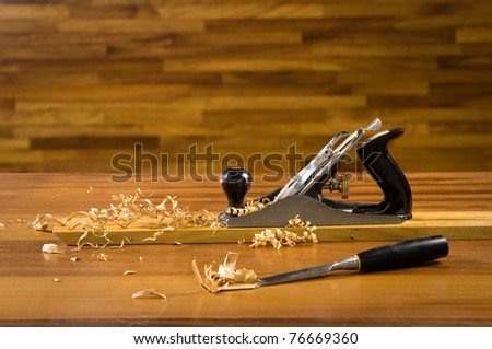 Wood planer on workbench with wood shavings.