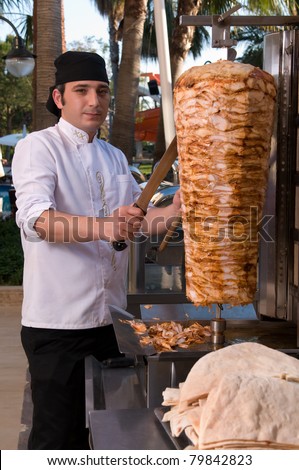 Chef slicing Turkish doner kebab