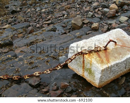 cement block with rusty chain