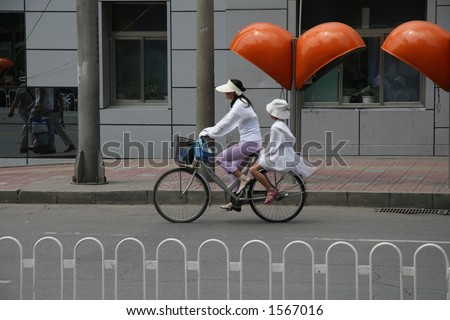 mother daughter on bicycle