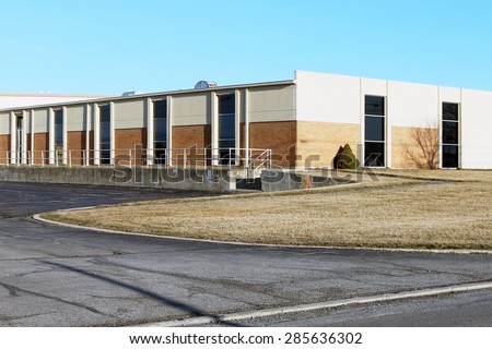 Small industrial building that combines a manufacturing work or warehouse area along with office space.