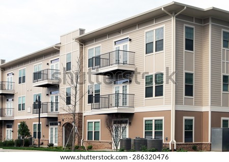 Modern 3 story apartment or condominium building in a suburban location.