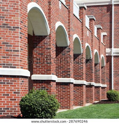 Brick arches outline a walkway at a university or college.