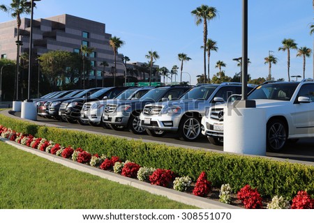 NEWPORT BEACH, CA-AUGUST, 2015:  Shiny Mercedes Benz automobiles are lined up outside this dealer in Southern California.