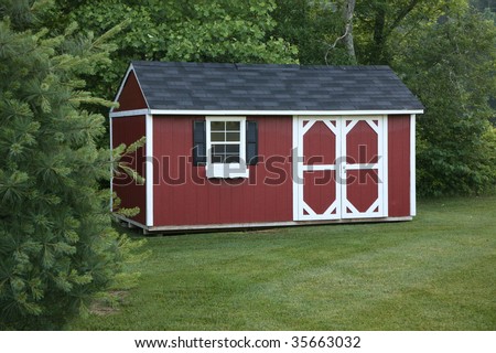 Lawn storage shed in a well landscaped setting.
