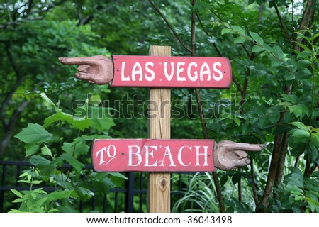 Hand carved sign pointing to vacation alternatives