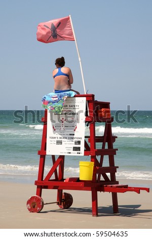 DAYTONA BEACH, FL - CIRCA 2009:Unidentified female lifeguard scans the surf for emergencies circa 2009 in Daytona Beach.  The Beach is widely considered the shark bite  capital of the world.